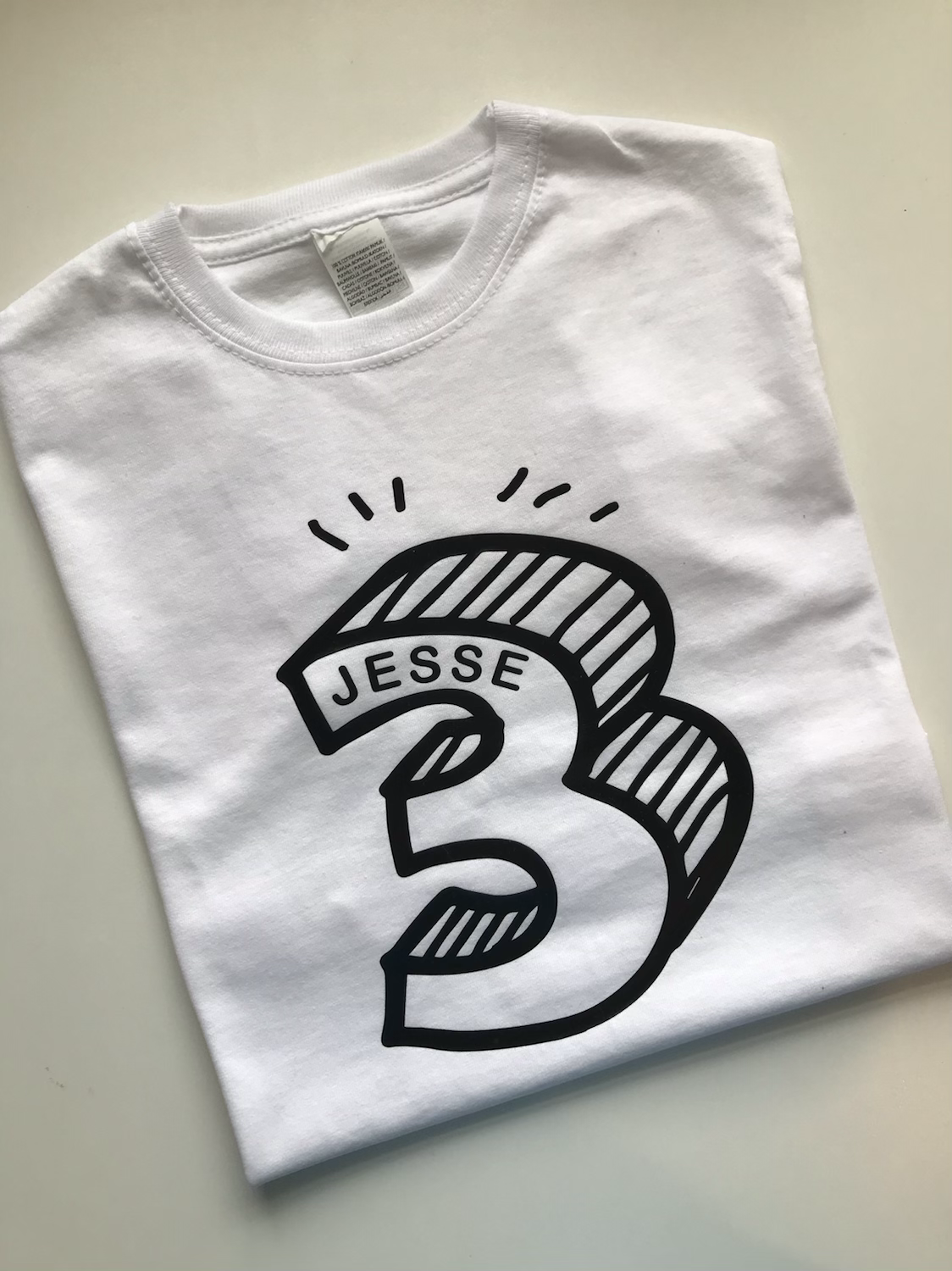 Colourful kids birthday shirt with embroidered name and funky graphics
